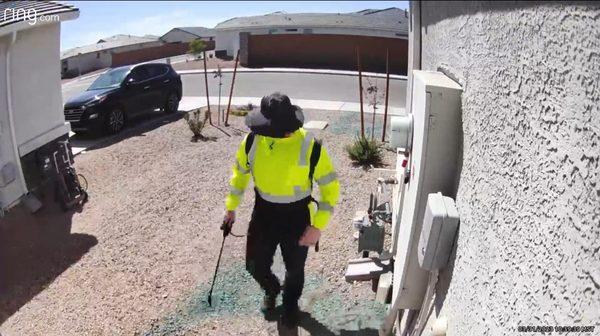 Technician applying weed killer spray.