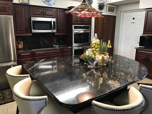 Remodeled Kitchen done by Apollo Kitchen & Bath featuring striking cabinetry and Granite countertop.