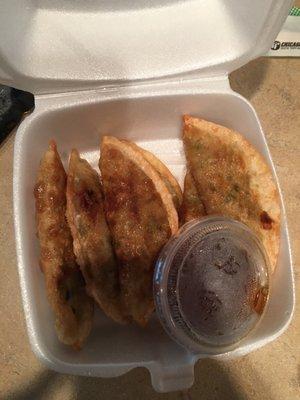 Gyoza with a dipping sauce.