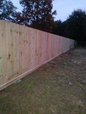 Fence made out of treated pine with 2x6 inch base board