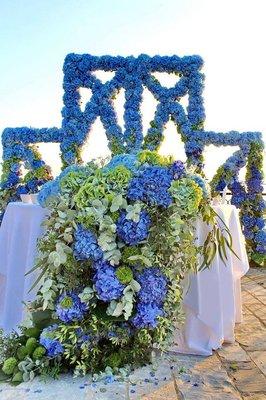 Wedding ceremony hydrangea arch and altar floral runner