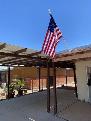 Concrete slab pour and covered parking tied into existing porch. We threw the flag in because this customer is a vet