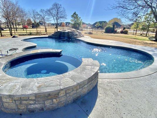 Custom gunite pool and spa combo with rock feature.