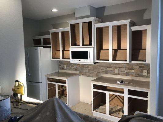 Cabinet fronts primed and refinished.