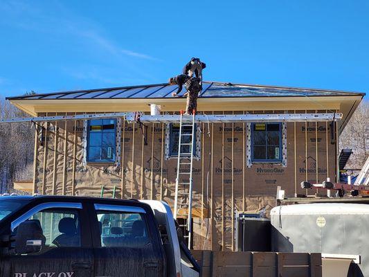 Installing a new Classic Bronze Standing Seam Metal Roof.