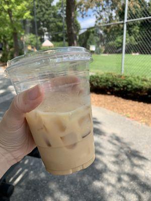 Enjoying a Revival chai latte at a picnic table