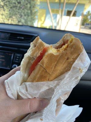 Egg, cheese, tomato breakfast sandwich.