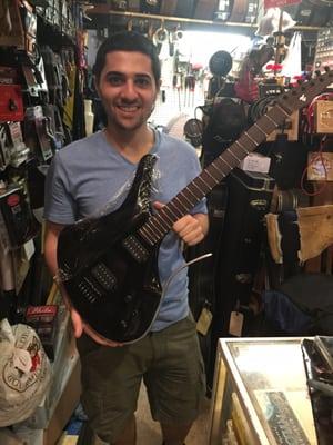 A young luthier with his hand crafted guitar. #godson