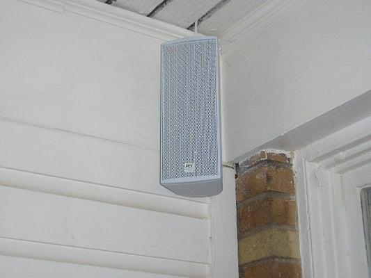 Outdoor speaker mounted on a covered deck.