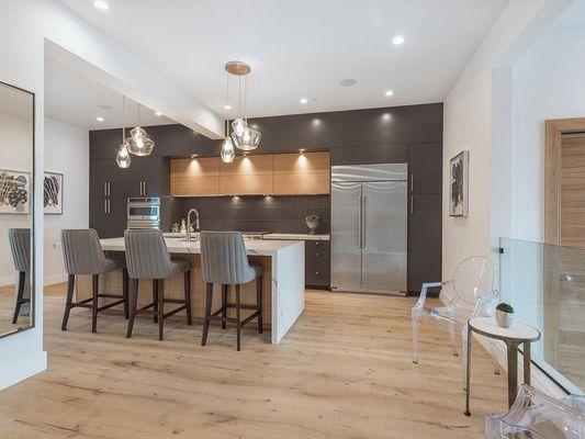 Kitchen remodel with custom cabinets, open layout, and new light fixtures