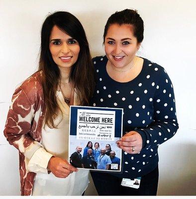 The manager , Alyssa Hodge and the RN supervisor, Mariam Kamyab holding a sign that all are welcome here!