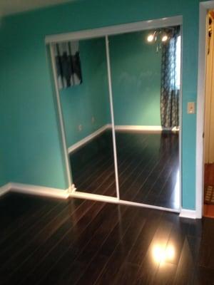 Complete installation of new laminate flooring, Mirror closet doors, base board and door trim, and new room paint.