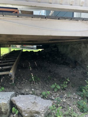 Before, rocks piled in center against house