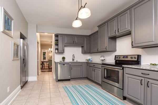 The kitchen boasts custom granite counters, new name brand stainless steel appliances, extensive cabinet space, & a spacious layout.