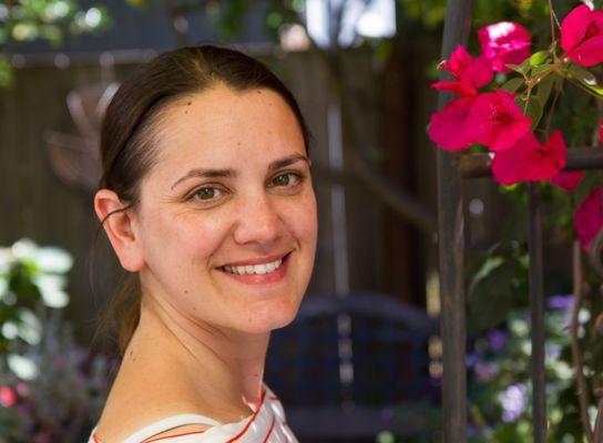 Young woman next to bougainvillea.