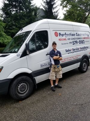 A Perfection Contracting employee standing in front of our service truck.