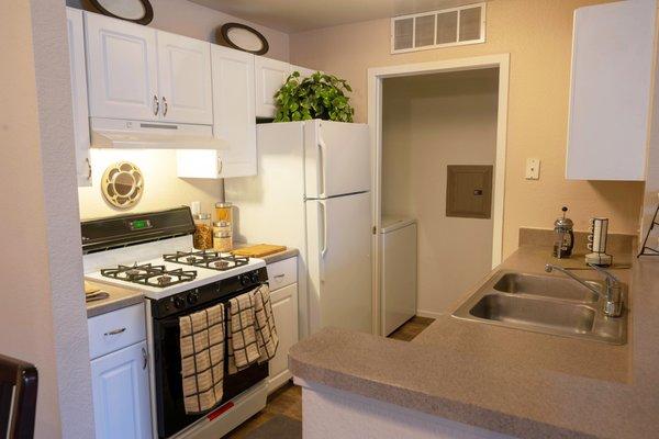 Kitchen with Access to Laundry Room - Waterford Pines Apartments in Waterford, MI