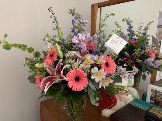 Lillies, Stock, Gerber Daisies, Alstroemeria,  Bells of Ireland, Waxflower, and Delphiniums. Perfection!