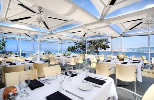 HeatRay Umbrellas, built for 75mph winds, integrated with HeatRay Non-Glowing heaters, protecting an ocean front terrace in La Jolla, CA