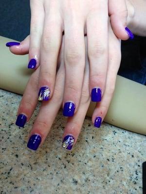 Gel polish nails with a design on the ring finger