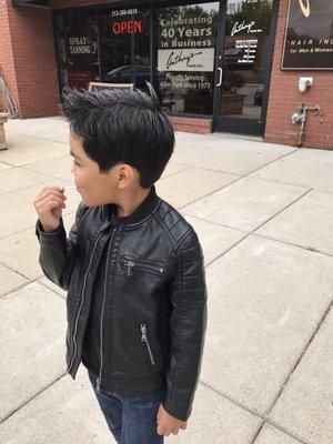 My son outside the salon after his haircut.