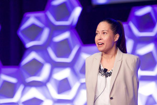 Jessica Cox speaking on stage in New Zealand.