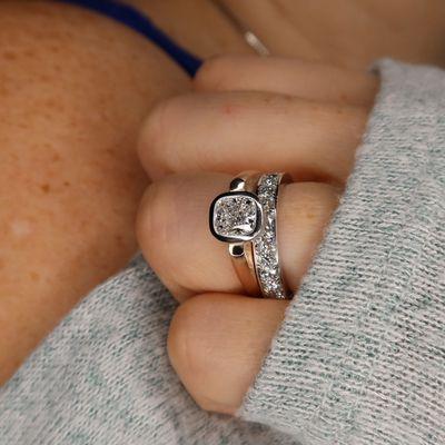 Cushion floating bezel engagement ring with eternity band