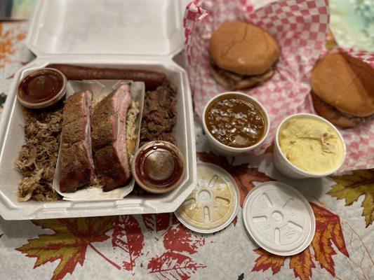 Sampler with a side of baked beans and potato salad & 2 pulled pork sandwiches