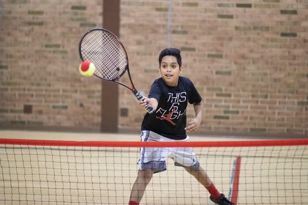 Kids learn the basics of tennis through intermediate skills at Somerville YMCA.