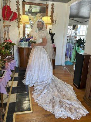 Mitch in wedding dress posing during embarrassing lost bet