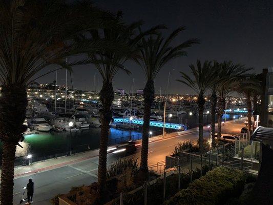 Zoomed out view of marina at night (from second balcony)