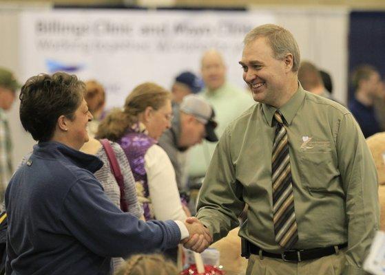 Dr. Zaugg greets visitors at health show.