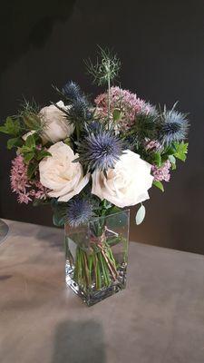 Roses, dutch thistle, seeded eucalyptus, allium and rice flower