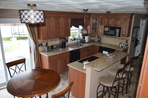 Wolf Classic maple cabinetry in Attleboro has loads of storage and warm tones. Designed and Installed by Attleboro Kitchen and Bath.