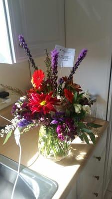 Someone needs to take a flower arranging/art 101 class - red & purple flowers NOT ATTRACTIVE - is this a fall bouquet??