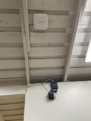 Ethernet switch on wall and wireless access point on ceiling of my garage