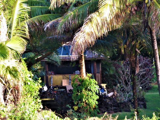 Oceanfront Bali hut taken from the ocean and old lava fields.