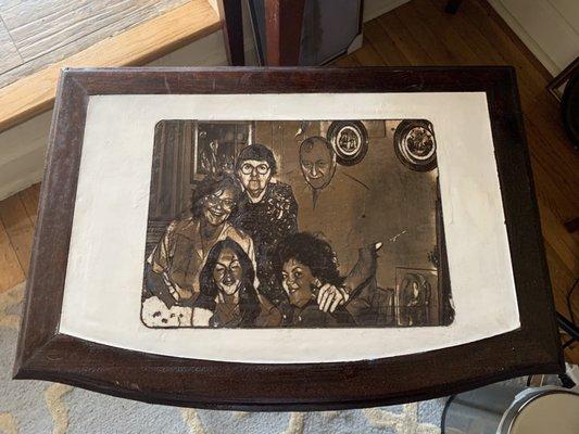 Custom table design. He painted the messed up leather, engraved the photo and re-stained the table beautifully!