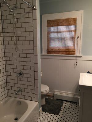 Bath redone 1920's style! Complete with subway tile, wainscoting, and hex floor tile. Nicole Curtis would be proud, no doubt...