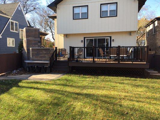 New composite deck with an outdoor kitchen and fireplace.