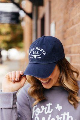 Woman holding Navy Fort Worth hat