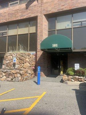 The entrance is around the left side of the building. The front has a massage place.