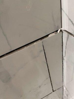 tile is popping out from uneven wall