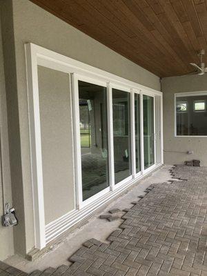 Pocket slider replacement with new vinyl triple pane sliding glass door and a new poured concrete sill.