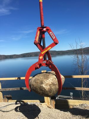 Rocklift being used to move boulders for erosion control. Three sizes of the Rocklift are available in 3,000, 6,000 and 12,000 lb capacities