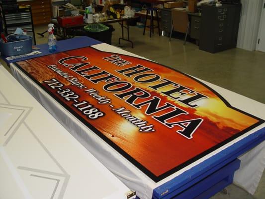 Sign design print and laminated vinyl mounted to panel sign.