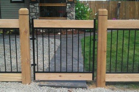 Ornamental iron fence with cedar frame.