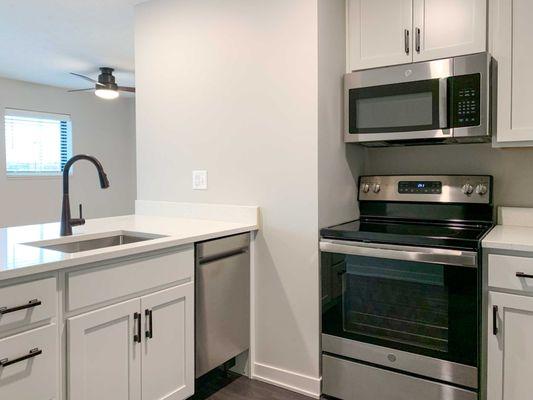 The Finch studio apartment with white cabinets.