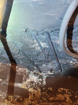 Exposed steel rebar at concrete basement ceiling,