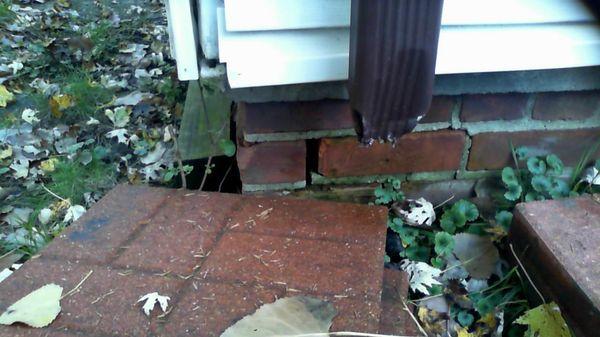 We check downspout and foundation issues as shown in photo